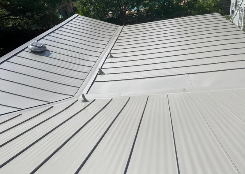 Solar attic fan installed on a metal roof for Roof Ventilation in Longwood